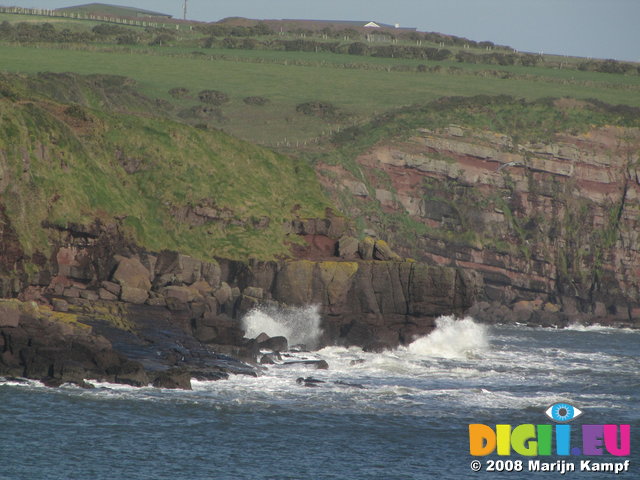 SX01390 Waves crashing against cliffs near Dunmore East